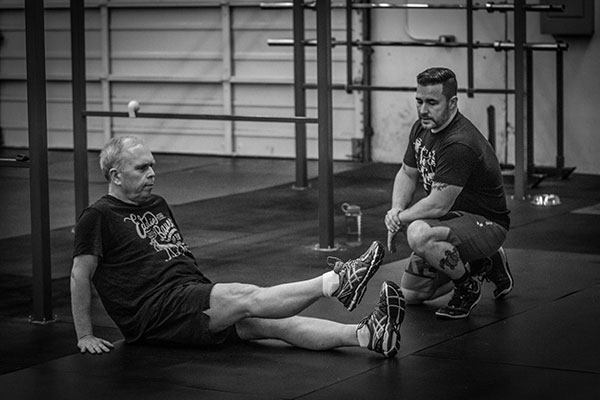 Crossfit Coach working with client